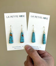 Load image into Gallery viewer, Close view of faux turquoise clay dangles with gold-tone fishhooks.
