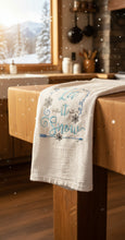 Load image into Gallery viewer, Embroidered towel with 'Let it Snow' text on a dark background
