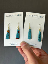Load image into Gallery viewer, Faux turquoise clay dangles on display cards against a dark background.

